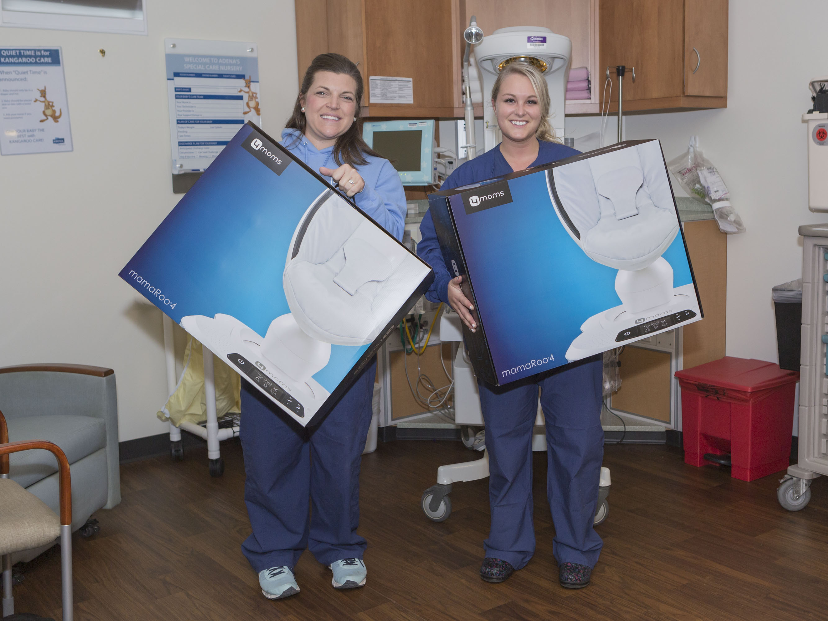 Two nurses holding mamaRoos
